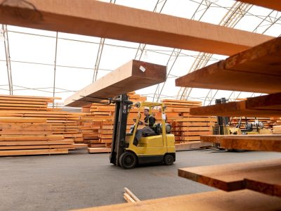 Wood mill and timber manufacturer. Male working in manufacturing. Industry and blue collar employment.
